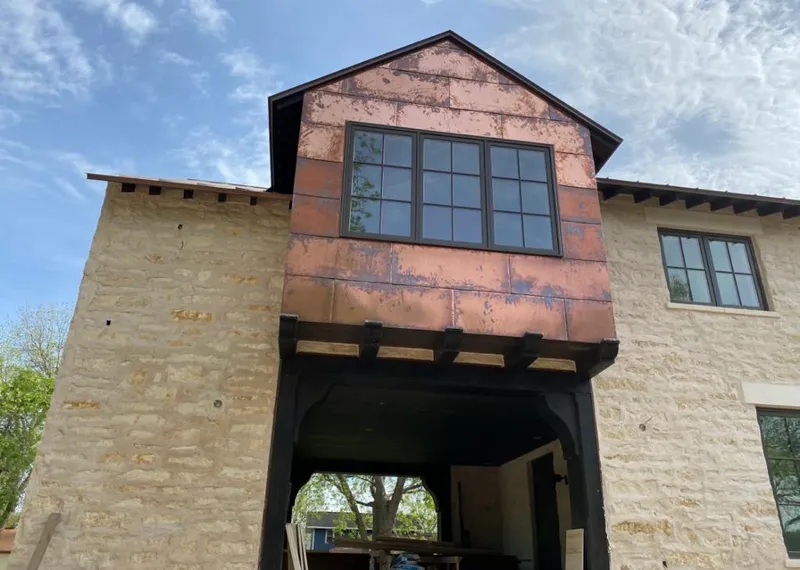Copper metal panel facade on a stone building for Skylight Installation in Socorro
